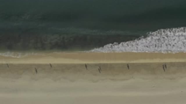 EAST CAPE BCS MEXICO-2019: People Walking At The Beach While The Waves Hit The