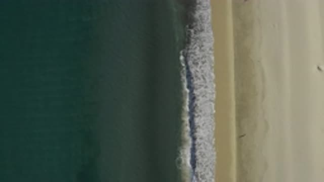 EAST CAPE BCS MEXICO-2019: Waves Break On A Sandy Shore Creating Froth And