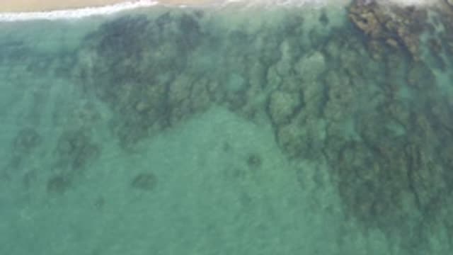 EAST CAPE BCS MEXICO-2019: View Of Tan Rocks Under Pale Blue Water On A Clear