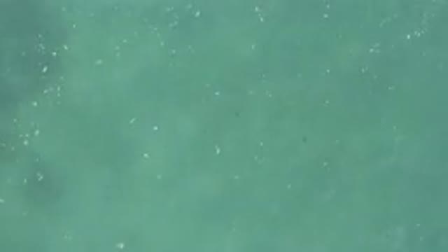 Aerial View Of Turquoise Sea With White Foam