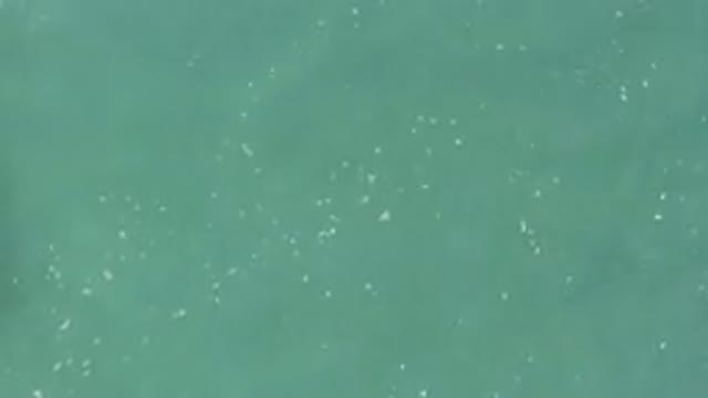 Aerial View Of Turquoise Water With White Foam