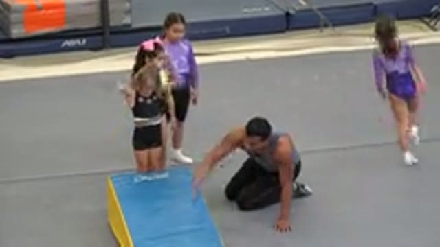 CABO SAN LUCAS MEXICO-2020: Small Girls Do Somersaults On Gym Mat With Help Of Instructor