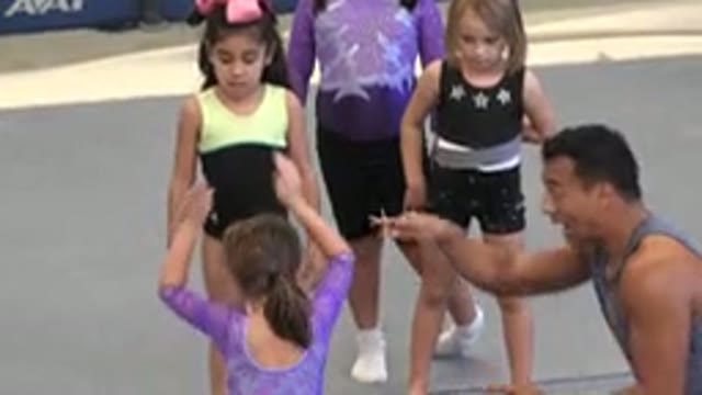 CABO SAN LUCAS MEXICO-2020: Trainer Teaching A Little Gymnast To Somersault