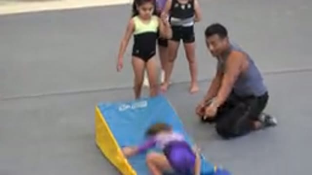 CABO SAN LUCAS MEXICO-2020: Young Gymnast Performs Somersault As Friends And Coach Cheer