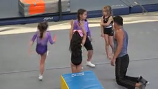 CABO SAN LUCAS MEXICO-2020: Happy Female Children Learning Gymnastics By A