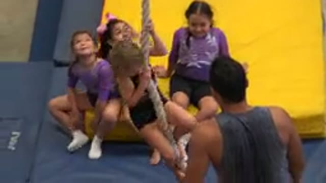 CABO SAN LUCAS MEXICO-2020: A Young Blonde Girl Attempts To Climb A Rope While