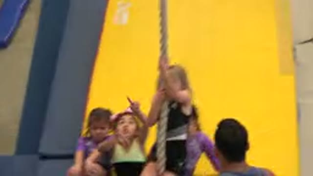 CABO SAN LUCAS MEXICO-2020: Girls Coaching A Child On A Yellow Mat With Rope