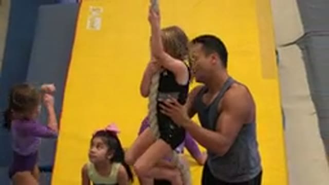 CABO SAN LUCAS MEXICO-2020: Gymnastics Coach Helps Little Girl To Climb Down A Rope