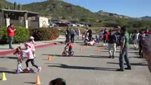 CABO SAN LUCAS MEXICO-2020: Kids Bikes Race Down Hill with Parents Watching