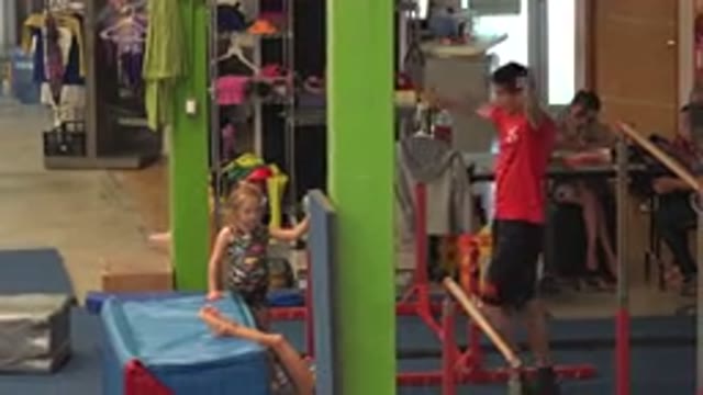 CABO SAN LUCAS MEXICO-2020: Young Gymnastics Instructor Redirecting Young Child
