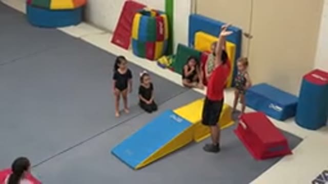 CABO SAN LUCAS MEXICO-2020: Man Wearing Red Shirt Holds Arms Up In Air While Standing