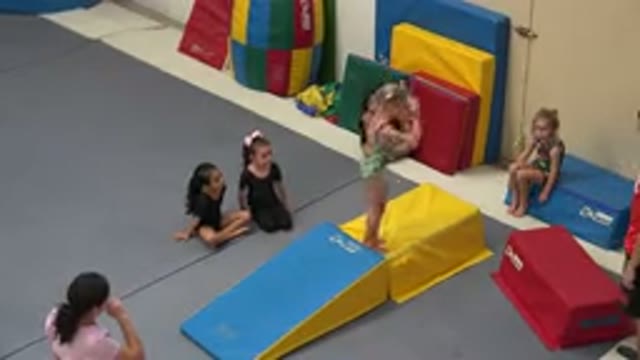 CABO SAN LUCAS MEXICO-2020: Girl Wearing Green Leotard Stands On Yellow Padded Cube