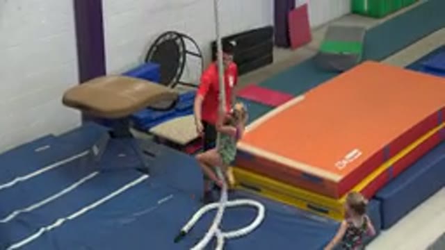 CABO SAN LUCAS MEXICO-2020: A Young Toddler Aged Gymnast Practicing Swinging On