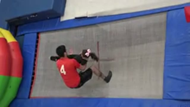 CABO SAN LUCAS MEXICO-2020: A Spotter Catches A Little Girl As She Jumps From A Trampoline