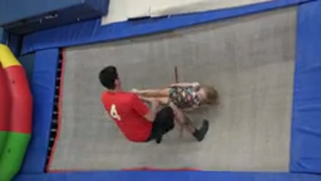 CABO SAN LUCAS MEXICO-2020: A Child Bounces On A Trampoline And Into The Arms