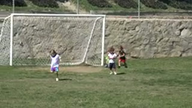 LOS CABOS MEXICO-2019: Children Running and Playing Soccer in Front of a Rock Wall
