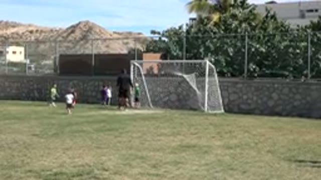 LOS CABOS MEXICO-2019: Many Small Children On A Soccer Field Playing Soccer With