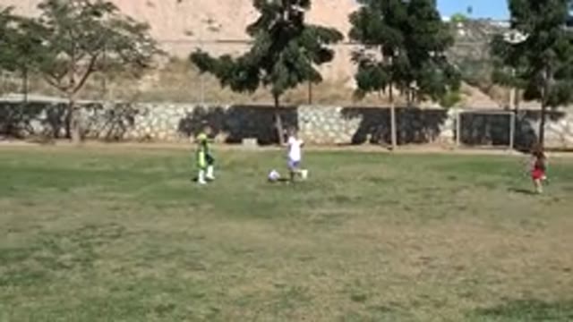 LOS CABOS MEXICO-2019: Kids Playing Soccer While Boy Wearing Green Almost Gets A Goal