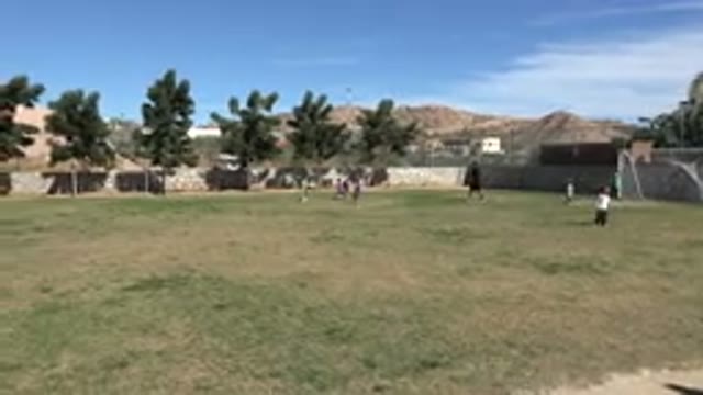 LOS CABOS MEXICO-2019: Coach Watching Kids Playing Soccer In A Field On A Sunny