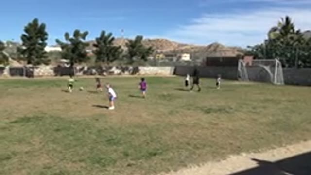 LOS CABOS MEXICO-2019: Child Looks Back At Camera During Soccer Game