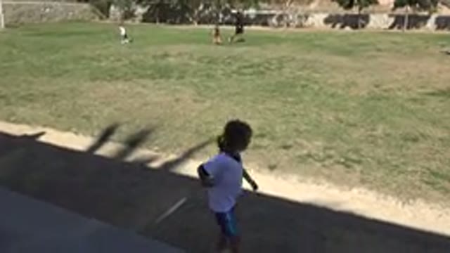 LOS CABOS MEXICO-2019: Child Watches Friends Playing Soccer And Waiting In Shade