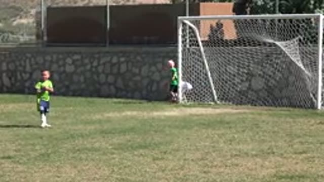 LOS CABOS MEXICO-2019: Child Wearing Blue Shorts Sets Ball Down Near White Goal