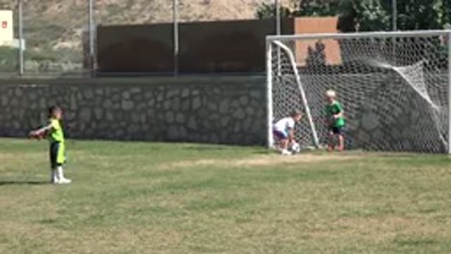 LOS CABOS MEXICO-2019: Four Young Children Playing Soccer On A Large Soccer Field