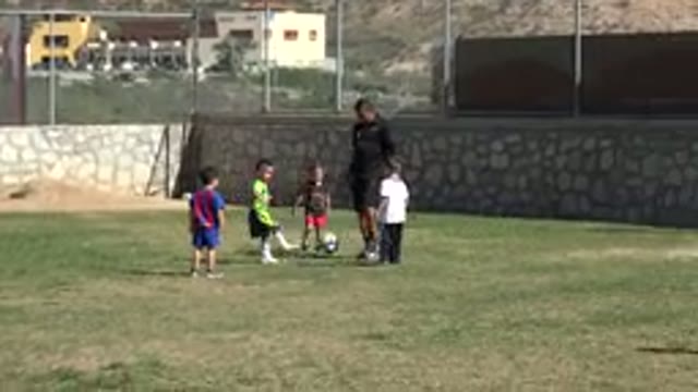 LOS CABOS MEXICO-2019: Small Children Playing Soccer Under Adult Supervision At