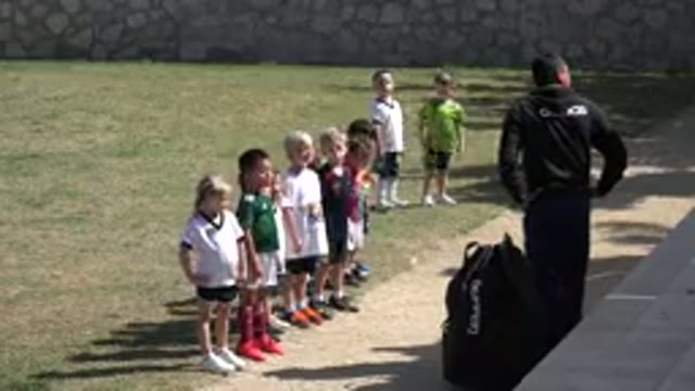 LOS CABOS MEXICO-2019: Man Wearing Black Jacket Watches Kids Do Warm-Up Exercises