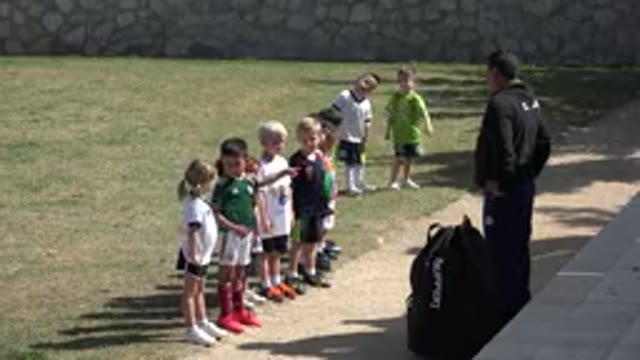 LOS CABOS MEXICO-2019: A Coach And His Soccer Team Of Children Warming Up Before
