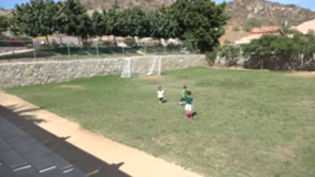 LOS CABOS MEXICO-2019: A Few Children Standing On A Soccer Field Then Running
