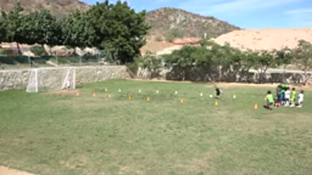 LOS CABOS MEXICO-2019: Coach Assists Ten Children Learning To Play Soccer On