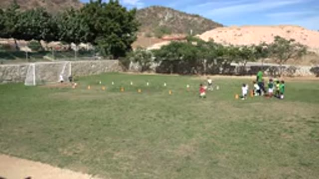 LOS CABOS MEXICO-2019: Children Playing Soccer While Teammate Jumps With Excitement