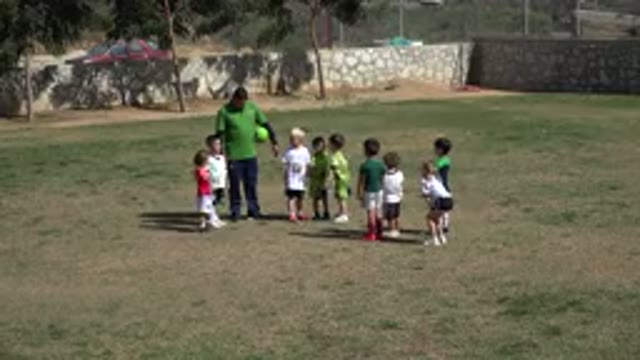 LOS CABOS MEXICO-2019: Children Are Divided Into Two Teams By A Man Who Organizes A Soccer Game
