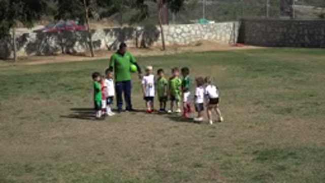 LOS CABOS MEXICO-2019: Boy Wearing Dark Blue Shirt Runs Toward Kids Standing