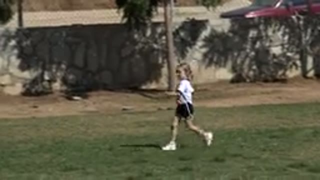 LOS CABOS MEXICO-2019: Short Blonde Girl Dressed in White Running on a Soccer Field