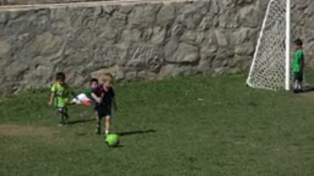 LOS CABOS MEXICO-2019: Small Children Kick A Soccer Ball While The Coach Assists