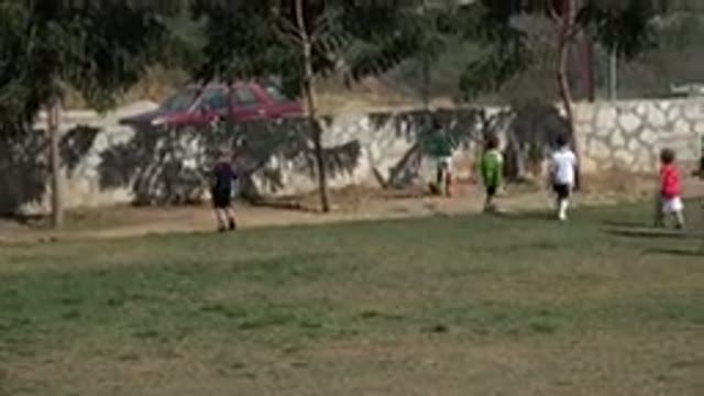 LOS CABOS MEXICO-2019: Children Chase Soccer Ball During Practice With Parent Watching