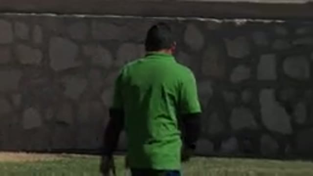 LOS CABOS MEXICO-2019: A Man Wearing A Green Shirt And Blue Pants Walks Next To