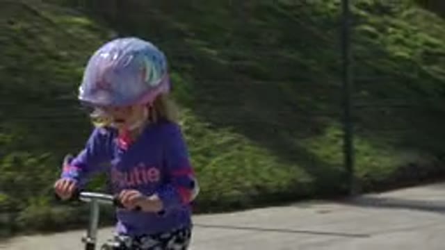 LOS CABOS MEXICO-2019: Little Girl Smiling While Riding Scooter