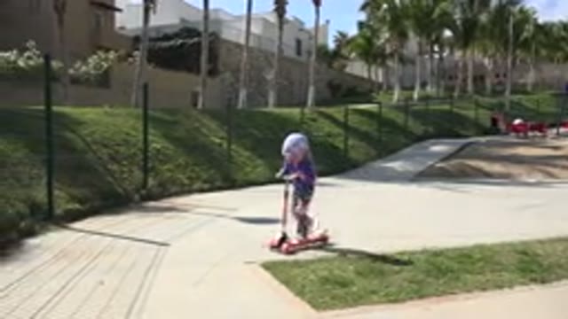 LOS CABOS MEXICO-2019: A Little Girl Is Learning How To Use A Scooter In A Sunny