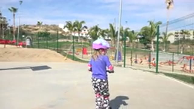 LOS CABOS MEXICO-2019: Little Girl Practicing How to Ride a Scooter