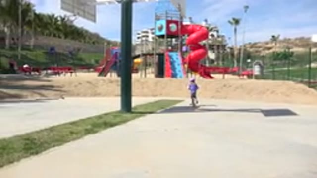 LOS CABOS MEXICO-2019: Child Wearing Purple Shirt Rides Orange Scooter While