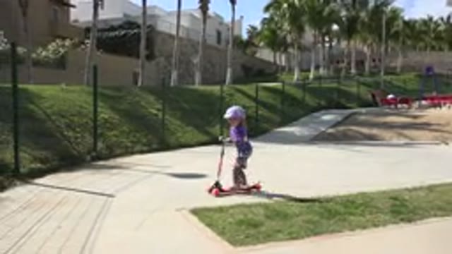LOS CABOS MEXICO-2019: Small Girl Rides Her Scooter in the Park on a Sunny Day