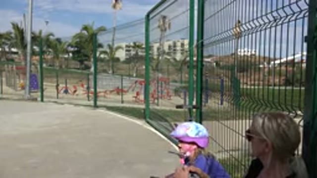 LOS CABOS MEXICO-2019: Young Girl With Mother Getting Ready To Ride Her Scooter
