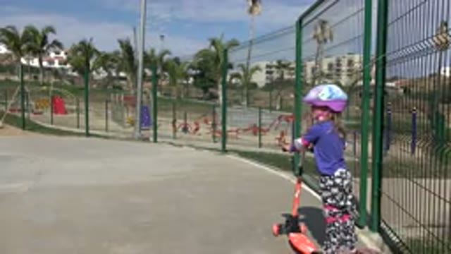 LOS CABOS MEXICO-2019: The Tired Little Girl Gets Off Her Scooter In The Park