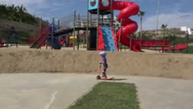 LOS CABOS MEXICO-2019: Kid Riding A Scooter In The Park During A Sunny Day