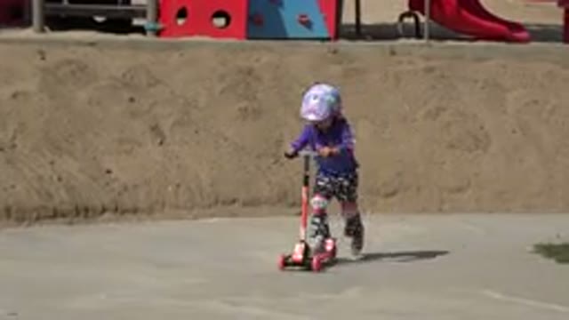 LOS CABOS MEXICO-2019: A Little Girl Is Riding A Scooter On A Pavement While