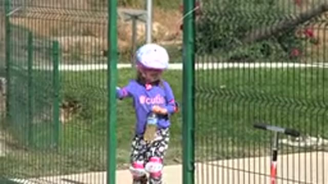 LOS CABOS MEXICO-2019: Child Opening Gate In A Park To Bring Drink To Parent