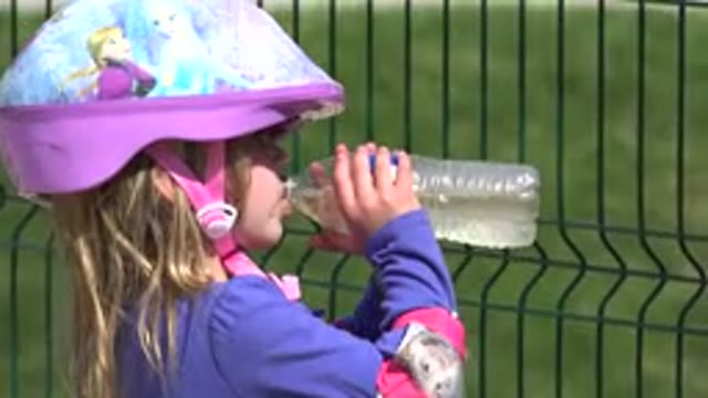 LOS CABOS MEXICO-2019: A Young Girl Takes A Break From Riding To Take A Drink Of Water